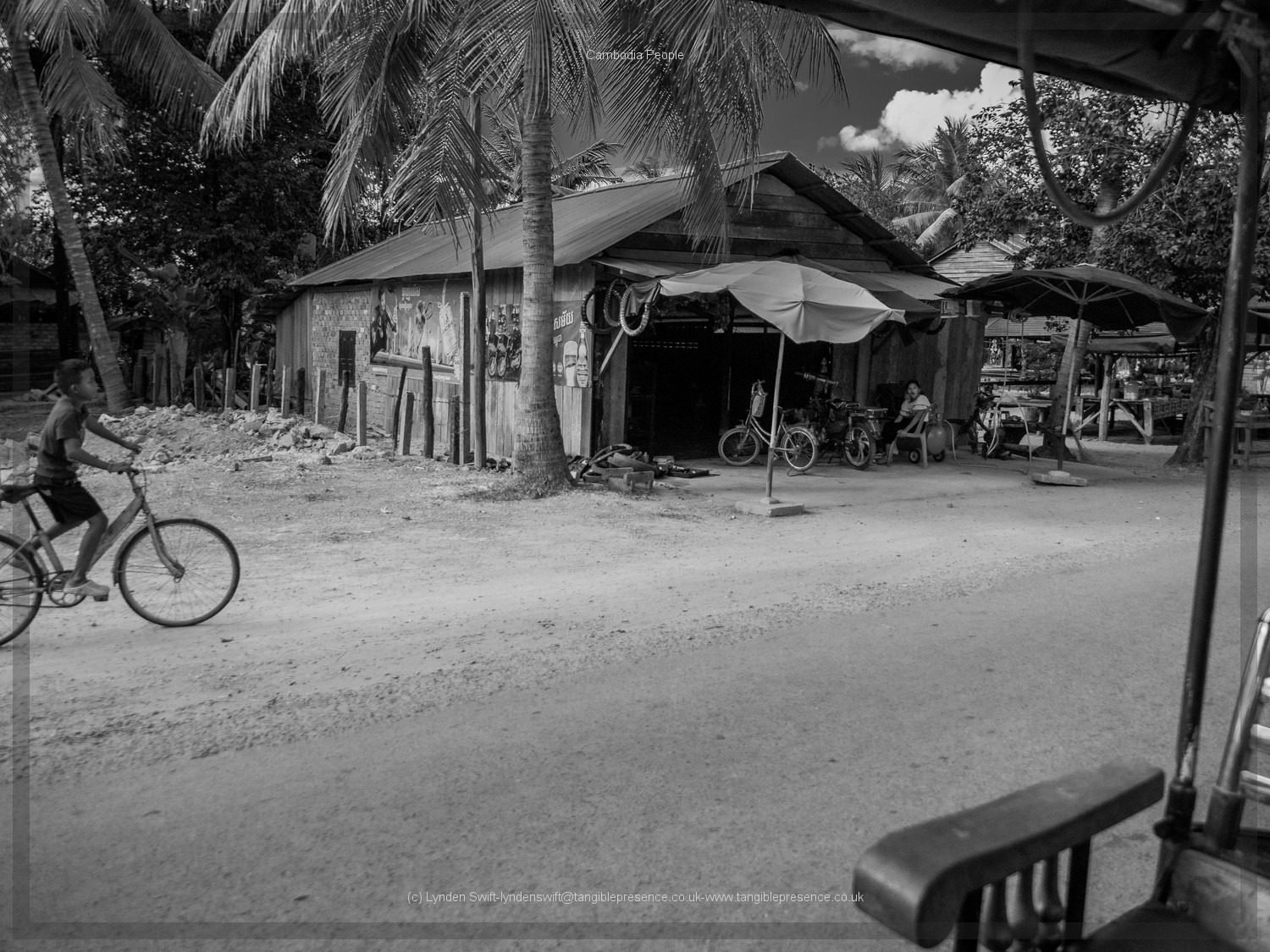  Child caught cycling. Cambodia. Lynden Swift. Tangible Presence Photography. 