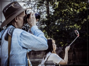  Older generation takes a picture of the place. Younger generation takes a picture of themselves.  